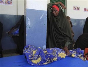 File photo courtesy Reuters.  A Somali woman weeps for her dead child at Banadir hospital in Mogadishu, July 21, 2011.  REUTERS/Feisal Omar