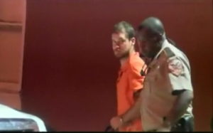 Police escort murder suspect Timothy Ray Jones.who admitted to killing his five children, aged nine to eight, in Alabama. (Photo grabbed from Reuters video/Courtesy Reuters)