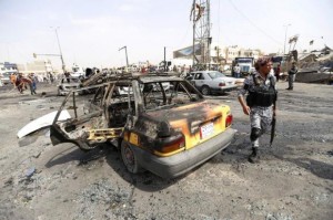 A member of the Iraqi security forces walk at the site of a car bomb attack in the New Baghdad neighbourhood August 26, 2014. REUTERS/Thaier al-Sudani