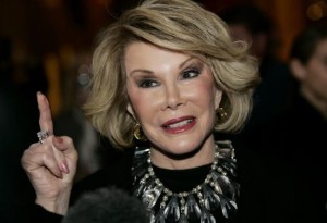 Comedian Joan Rivers talks to reporters as she arrives for a gala honoring the late stand-up comedian George Carlin, the 11th Annual Mark Twain Prize for American Humor recipient, at the Kennedy Center in Washington November 10, 2008.    REUTERS/Molly Riley