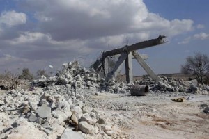 A damaged site is seen in what activists say was a U.S. strike, in Kfredrian, Idlib province September 23, 2014. REUTERS/Abdalghne Karoof