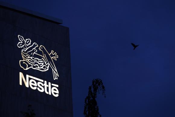  A bird flies past the logo at the headquarters of world food giant Nestle in Vevey October 16, 2014. Credit: Reuters/Denis Balibouse 