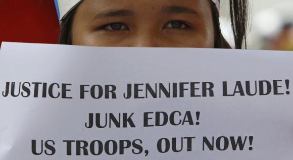 A student displays a placard during a protest rally against the killing of a 26-year-old Filipino transgender Jennifer Laude, outside the U.S. embassy in Manila October 14, 2014. CREDIT: REUTERS/ERIK DE CASTRO