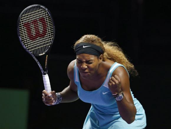 Serena Williams reacts as she plays against Simona Halep of Romania during their WTA Finals singles tennis match at the Singapore Indoor Stadium October 22, 2014. CREDIT: REUTERS/EDGAR SU