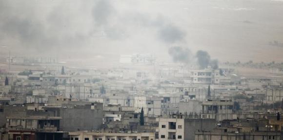 Smoke rises from the Syrian town of Kobani, seen from near the Mursitpinar border crossing on the Turkish-Syrian border