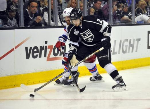 Jun 7, 2014; Los Angeles, CA, USA; Los Angeles Kings defenseman Slava Voynov (26) battles for the puck with New York Rangers center Brad Richards (19) in the second period during game two of the 2014 Stanley Cup Final at Staples Center. Mandatory Credit: Gary A. Vasquez-USA TODAY Sports