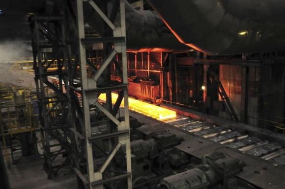 A red-hot slab of metal is transported on a production line at a hot rolling workshop of the Novolipetsk (NLMK) steel mill in Lipetsk, about 500 km (311 miles) southeast of the capital Moscow, January 30, 2014. Picture taken January 30, 2014. CREDIT: REUTERS/ANDREY KUZMIN