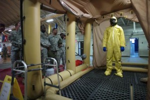 A soldier goes through the decontamination process with U.S. Army soldiers from the 101st Airborne Division (Air Assault), who are earmarked for the fight against Ebola, take part in training before their deployment to West Africa, at Fort Campbell, Kentucky October 9, 2014. REUTERS/Harrison McClary