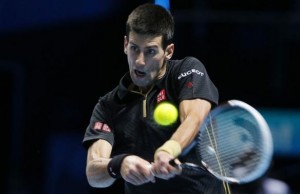Djokovic of Serbia returns the ball to Wawrinka of Switzerland during their tennis match at the ATP World Tour finals at the O2 Arena in London