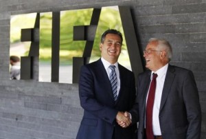 Garcia, Chairman of the investigatory chamber of the FIFA Ethics Committee and Eckert, Chairman of the adjudicatory chamber of the FIFA Ethics Committee shake hands as they pose for photographers after at the at the Home of FIFA in Zurich