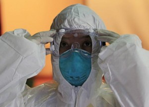 A health workers wears a protective suit and goggles during an Ebola response training session in Alabang
