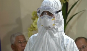 One of the medical workers in protection suits being presented to President Aquino and to members of the media. President Aquino said Friday that the Philippines is ready in the event of an Ebola case reaching the country. (Photo grabbed from Reuters video/Courtesy Reuters)