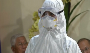 One of the medical workers in protection suits being presented to President Aquino and to members of the media. President Aquino said Friday that the Philippines is ready in the event of an Ebola case reaching the country.  (Photo grabbed from Reuters video/Courtesy Reuters)