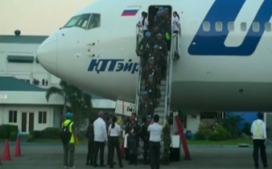 More than 100 Philippine peacekeepers from Liberia arrived at an airbase in Manila on Wednesday (November 12).  Their  loved ones watched their arrival on TV monitors because of the quarantine requirement for those coming from Ebola-infected regions.  (Photo grabbed from Reuters video/Courtesy Reuters)