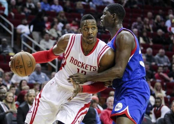 Nov 14, 2014; Houston, TX, USA; Houston Rockets center Dwight Howard (12) drives the ball as Philadelphia 76ers center Henry Sims (35) defends during the first quarter at Toyota Center. Mandatory Credit: Troy Taormina-USA TODAY Sports