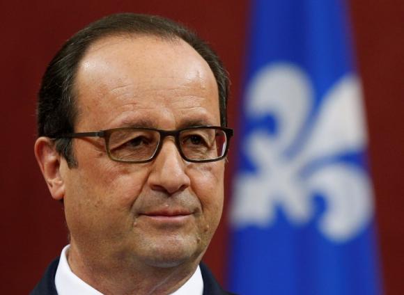 French President Francois Hollande listens to a question during a news conference at the National Assembly in Quebec City, November 4, 2014. CREDIT: REUTERS/MATHIEU BELANGER