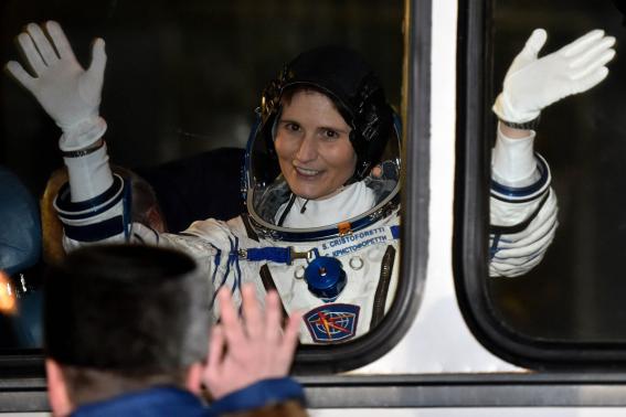 International Space Station (ISS) crew Samantha Cristoforetti of Italy waves from a bus at the Baikonur cosmodrome November 23, 2014.  CREDIT: REUTERS/KIRILL KUDRYAVTSEV/POOL