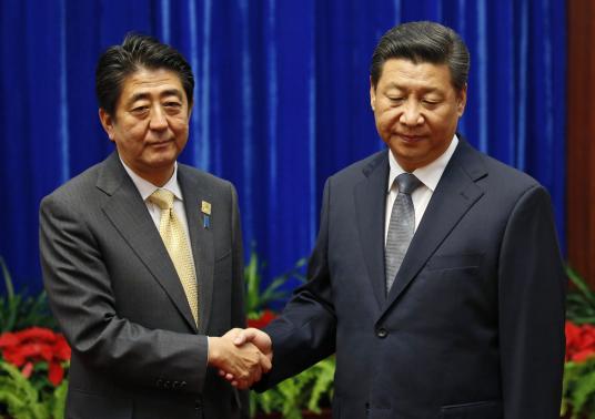 China's President Xi Jinping (R) shakes hands with Japan's Prime Minister Shinzo Abe during their meeting at the Great Hall of the People, on the sidelines of the Asia Pacific Economic Cooperation (APEC) meetings, in Beijing November 10, 2014. CREDIT: REUTERS/KIM KYUNG-HOON