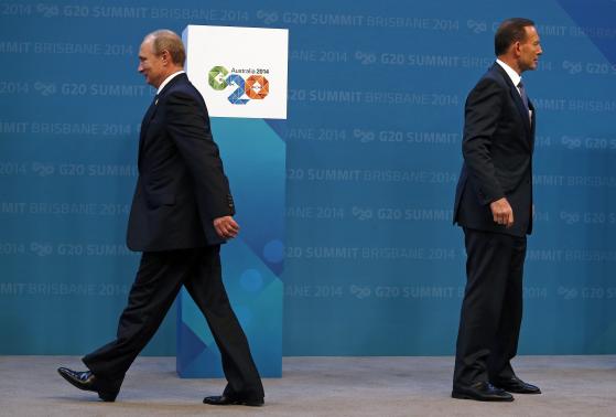 Australian Prime Minister Tony Abbott (R) stands near Russian President Vladimir Putin after officially welcoming him to the G20 leaders summit in Brisbane November 15, 2014. CREDIT: REUTERS/DAVID GRAY