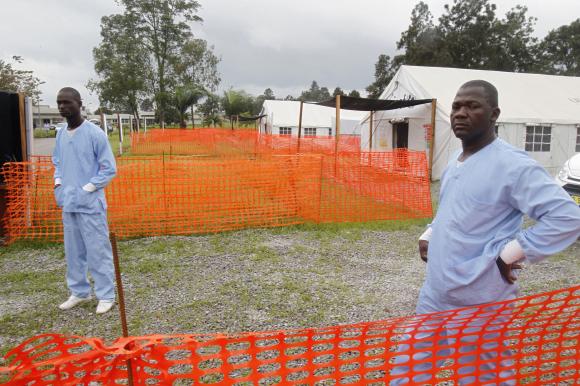 Health workers stand at an Ebola treatment unit at the main hospital of Yopougon in Abidjan October 25, 2014. CREDIT: REUTERS/LUC GNAGO
