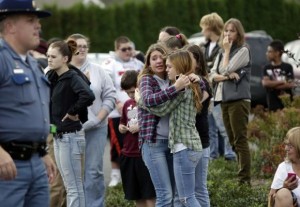 Two girls hug at Shoultes Gospel Hall church where families are reuniting after an active shooter situation at Marysville-Pilchuck High School in Marysville, Washington, October 24, 2014. REUTERS/Jason Redmond