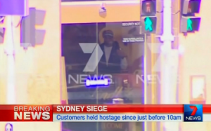 A man reported by local media to be a suspect in the hostage siege at a cafe in the Australian city of Sydney is caught on local television footage.  (Photo grabbed from Seven Network  Australia/Reuters video)