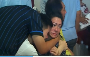 Relatives of passengers of the missing Indonesian Air Asia airbus grieve after hearing confirmation on recovered debris and bodies from the missing plane. (Photo grabbed from Reuters video)