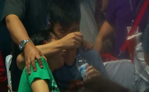 Families of passengers onboard missing AirAsia flight struggle to cope with their grief, after rescuers found wreckage and bodies in the sea off the coast of Borneo. (Photo grabbed from Reuters video)