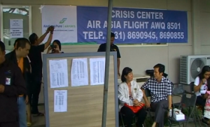 A crisis center set up in Indonesia for relatives of the 162 passengers of the missing Air Asia flight.  (photo grabbed from Reuters video/Courtesy Reuters)