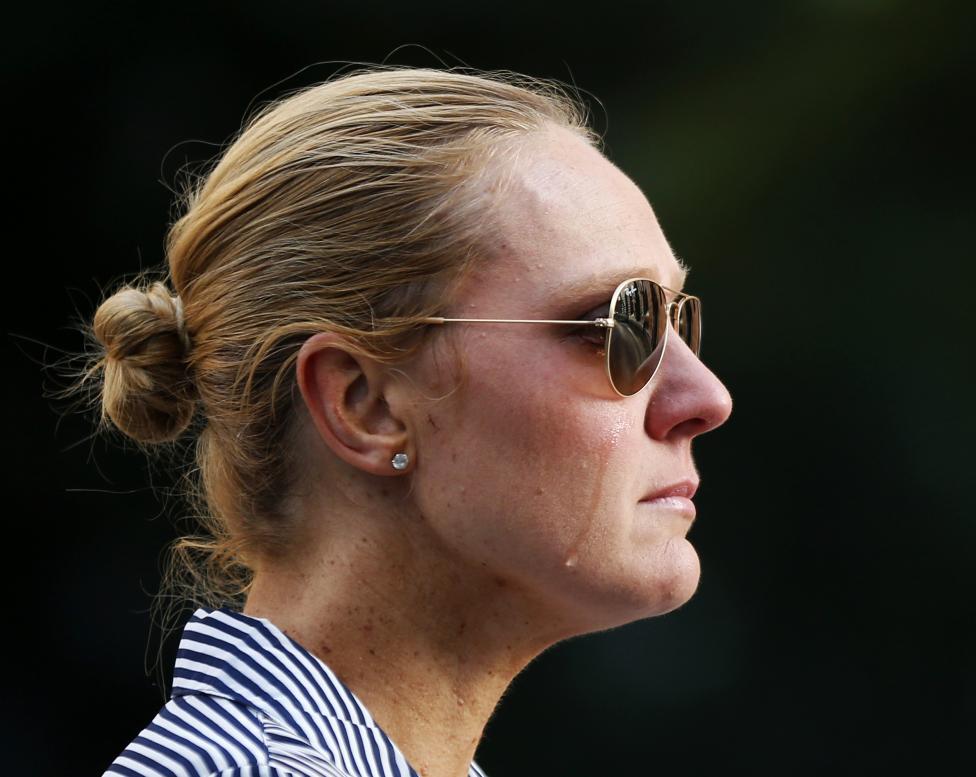 Sydney resident Kate Golder cries as she observes the site of a Sydney cafe siege after it ended