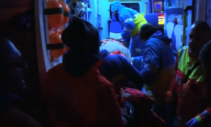 A rescued ferry passenger is placed inside an ambulance to be brought to a hospital in Italy's Brindisi. (Photo grabbed from Reuters video)