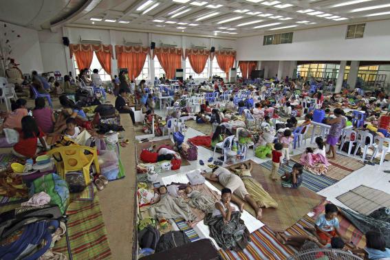 People take shelter inside a evacuation centre after evacuating from their homes due to super-typhoon Hagupit in Surigao city, southern Philippines December 5, 2014. T CREDIT: REUTERS/STRINGER