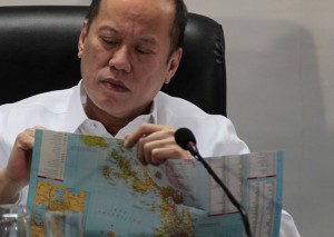 President Benigno S. Aquino III looks at a Philippine map as he listens to the updates on the government’s pre-disaster readiness preparation for Typhoon Ruby at the National Disaster Risk Reduction and Management Council (NDRRMC) meeting at the NDRRMC headquarters in Camp Aguinaldo in Quezon City on Thursday (December 04). (Photo courtesy Malacañang Photo Bureau)