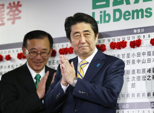 Japan's Prime Minister Shinzo Abe, who is also leader of the ruling Liberal Democratic Party (LDP), claps during an election night event at the LDP headquarters in Tokyo, December 14, 2014. CREDIT: REUTERS/TORU HANAI
