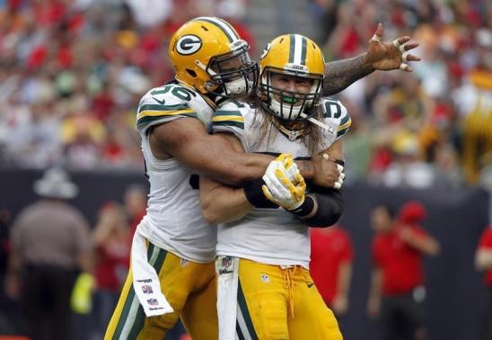 Dec 21, 2014; Tampa, FL, USA; Green Bay Packers outside linebacker Clay Matthews (52) is congratulated by defensive end Mike Neal (96) after he sacked Tampa Bay Buccaneers quarterback Josh McCown (not pictured) during the second half at Raymond James Stadium. Kim Klement-USA TODAY Sports