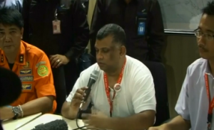 Malaysia AirAsia chief Tony Fernandes updates distraught relatives of missing Air Asia airbus passengers at a makeshift crisis center at the airport in Indonesia's second-largest city.
