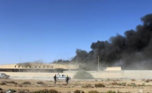 Black smoke billows from a warehouse after an airstrike in Zawura