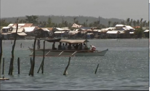 Ahead of the visit by the French president to the typhoon hit town of Guiuan in the Philippines, residents hope it will highlight the impact of extreme weather events and climate change upon local communities. (Courtesy Reuters/Photo grabbed from Reuters video)