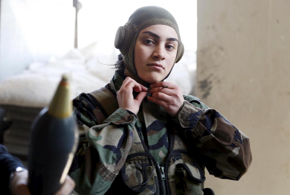 A member of a Female Commando Battalion which is part of the Syrian Army, wears her headgear in the government-controlled area of Jobar, a suburb of Damascus March 19, 2015. This Battalion consists of several hundred female fighters who have had military training and carry out combat duties. Picture taken during a Syrian Army organized trip. REUTERS/Omar Sanadiki