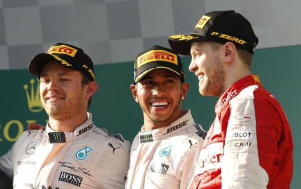 (L to R) Second placed Mercedes Formula One driver Nico Rosberg of Germany, race winner Mercedes Formula One driver Lewis Hamilton of Britain and third placed Ferrari Formula One driver Sebastian Vettel of Germany pose on the podium after the Australian F1 Grand Prix at the Albert Park circuit in Melbourne March 15, 2015.  REUTERS/Jason Reed