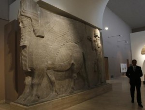  A man walks past human-headed winged bull statues from Khorsabad, at the Iraqi National Museum in Baghdad March 8, 2015. 
