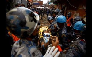 Nepal earthquake survivor Pema Lama, 15, is rescued by the Armed Police Force from the collapsed Hilton Hotel.