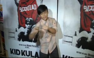 Teenage Filipino actor Buboy Villar, who portrays the young Manny Pacquiao in the movie, "Kid Kulafu", does a bit of shadow boxing for the press.  The movie premiered in Manila on Tuesday, April 14, ahead of the May 2 fight of the Filipino boxing champ and US boxing champ Floyd Mayweather in Las Vegas. (Photo grabbed from Reuters video/Courtesy Reuters)