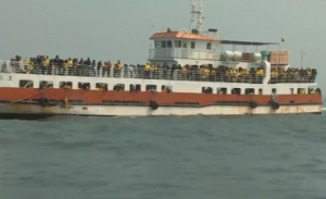 A ship carrying about 200 South Korean family members of the victims of the Sewol ferry disaster made the hour-long trip to the site of the sinking, where they threw white chrysanthemums into the sea. (Photo grabbed from Reuters video/ Courtesy Reuters)