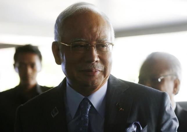 Malaysian Prime Minister Najib Razak arrives at a news conference to announce budget revisions to help its oil exporting economy adjust to the impact of slumping global crude prices, in Putrajaya January 20, 2015. REUTERS/Olivia Harris