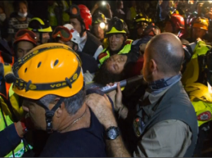 A woman in her late 20s, who was working as a maid in a Kathmandu hostel, is rescued after spending five days trapped with three bodies following the earthquake. Credit ISRAAID-MAGEN/Miki Noam Alon/ Photo grabbed from Reuters video