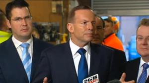 Australian Prime Minister, Tony Abbott, says he is confident officials "acted within the law" in dealing with people smugglers as calls grew for an inquiry into reports that Australian officials paid them to turn their boat back to Indonesia.  (Photo grabbed from Reuters video/Courtesy Reuters)
