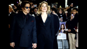 Johnny Depp's wife, actress Amber Heard, has been charged over illegally bringing dogs Boo and Pistol into Australia on a private jet and is due in court in September, Australia's ABC reported. (A photo capturred from Reuters video)