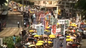 Tens of thousands of protesters take to the streets calling for free elections, and demanding the resignation of Chief Executive Leung Chun-ying. (Photo grabbed from Reuters video/Courtesy Reuters)