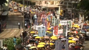 Tens of thousands of protesters take to the streets calling for free elections, and demanding the resignation of Chief Executive Leung Chun-ying.  (Photo grabbed from Reuters video/Courtesy Reuters)